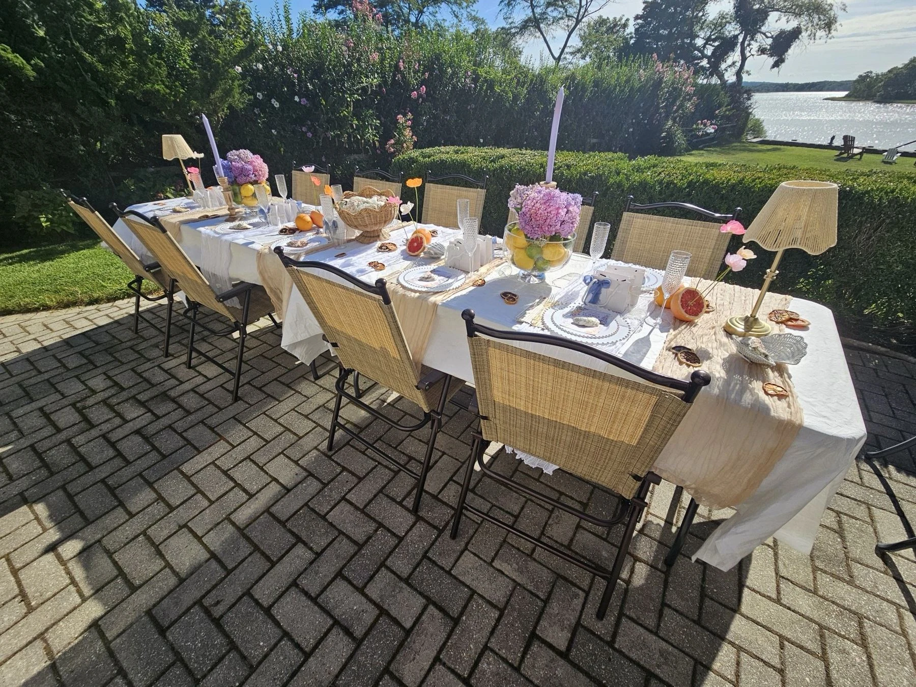The real Ladies’ Summer Soirée: a waterside table with citrus, woven lamps and lavender candles